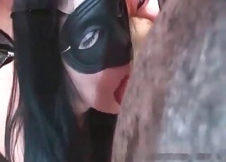 Masked chick sucking animal dick
